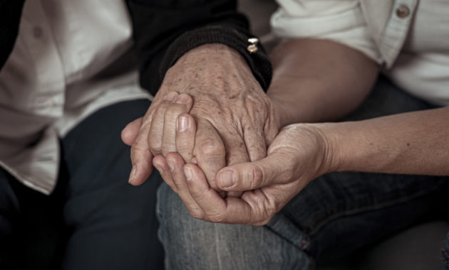 Mother and daughter hands holding together in love and support after loosing love ones amid coronavirus outbreak
