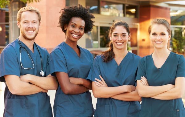 four personal support workers smiling for camera
